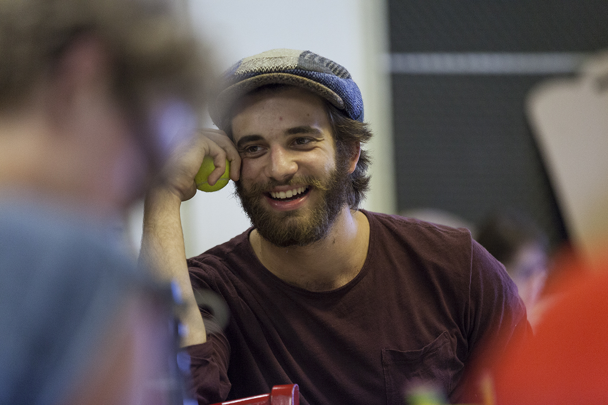 Andrew Richardson laughs during a table reading of Chelsea Marcantel's "Tiny Houses," one of the upcoming plays in the Chautauqua Theater Company's New Play Workshop, at 4:30 PM on July 11, 2016, in Studio B at Brawdy Theater Studios. Richardson plays the character Ollie, who sells haunted dolls on the Internet. Photo by Carolyn Brown.