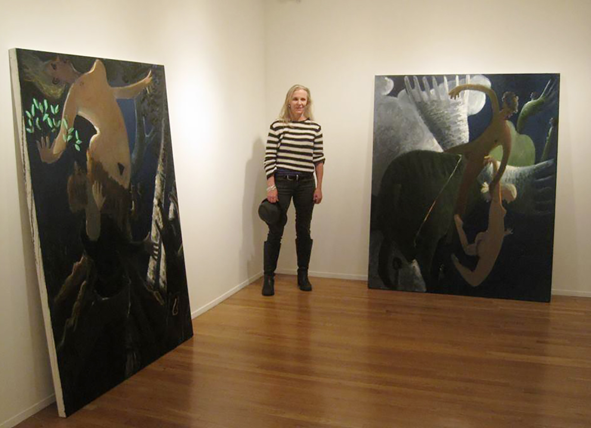 Kyle Staver stands near two of her large-scale works.
