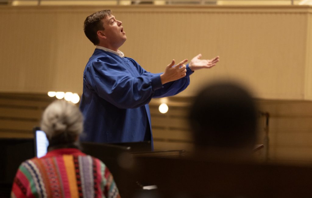 Joshua Stafford, director of sacred music and Jared Jacobsen Chair for the Organist, conducts the choir during the Sacred Song service at 8:00 PM on Jun. 30, 2024, in the Amphitheater.