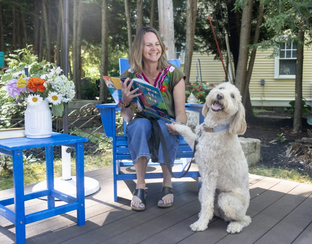 Pam Spremulli — illustrator of Chautauqua Dog Love, written by Lorrie Happ — with Charlie, a 3-year-old golden doodle.