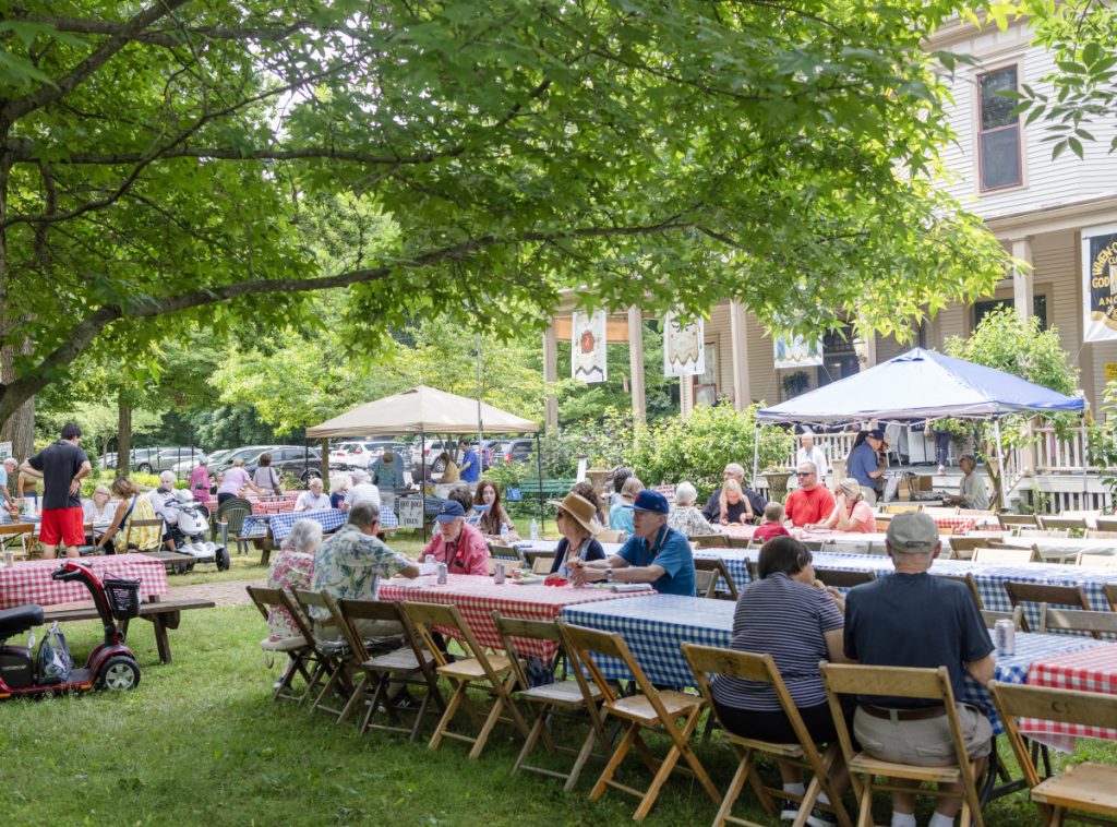 Chautauquans gather for the Great American Picnic and Silent Auction, programmed by the Alumni Association of the CLSC, July 16, 2023, on the lawn of the Literary Arts Center at Alumni Hall.