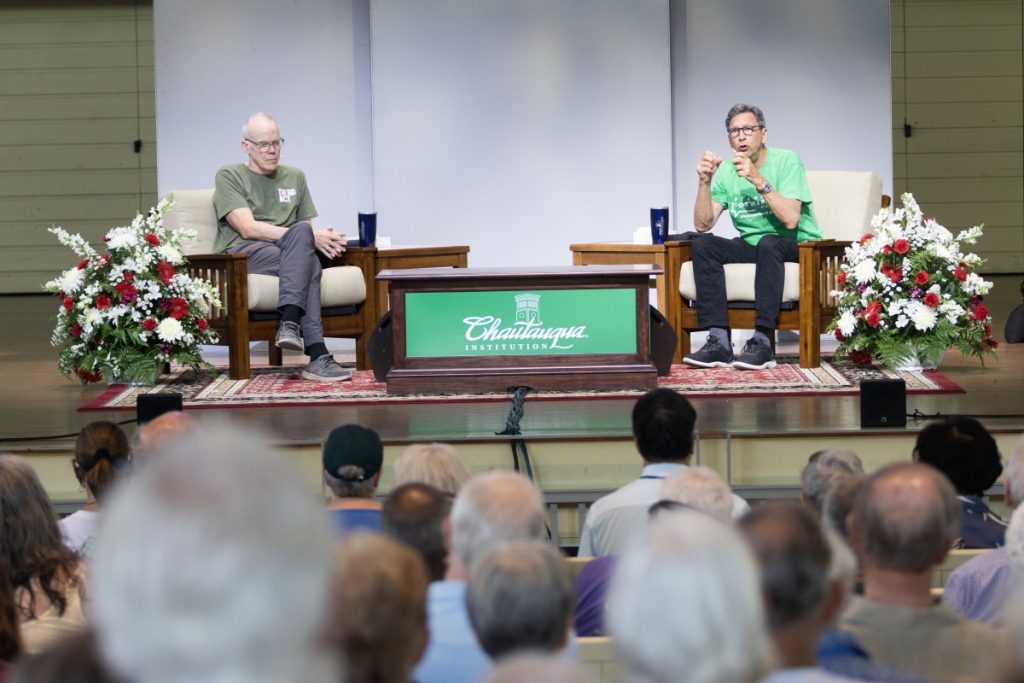 Environmentalist Bill McKibben, left, and journalist Frank Sesno discusses the importance of connecting older, younger generations in climate fight Wednesday in the Amphitheater.
